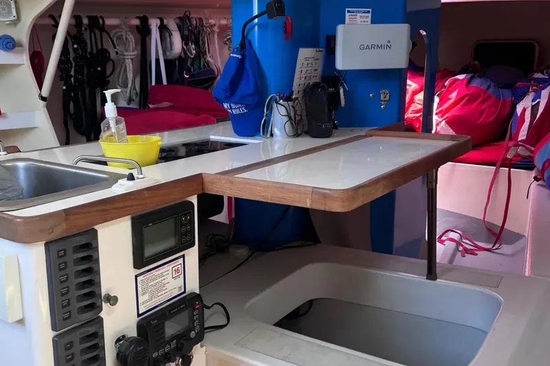 Slide: The Image of Interior of 2009 Class 40 Open Antrim yacht with navigation equipment and compact kitchen area. - 24