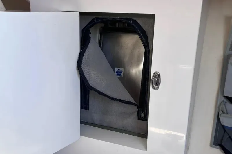 Slide: The Image of Open compartment on 2009 Class 40 Antrim Design boat, showing interior with zippered cover. - 27