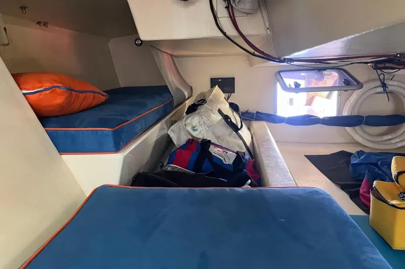 Slide: The Image of Interior of 2009 Class 40 Open Antrim yacht with blue cushions and storage bags. - 28