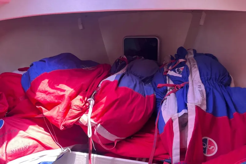 Slide: The Image of Interior of 2009 Class 40 Open Antrim Design sailboat with colorful sails stored. - 37