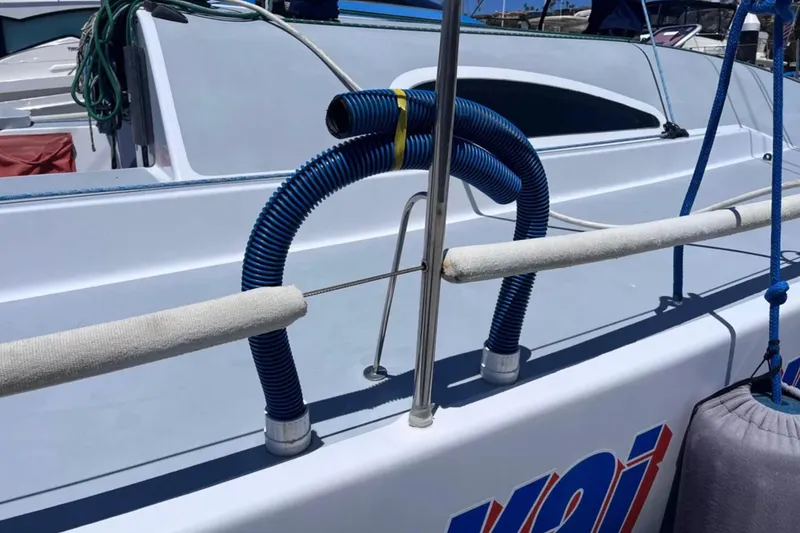 Slide: The Image of 2009 Class 40 Open Antrim Design yacht deck with blue hoses and railing. - 45