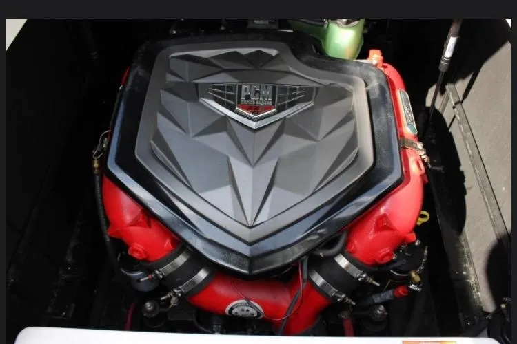 Slide: The Image of Engine of 2022 Nautique Super Air Nautique S23 with PCM branding, featuring red and black components. - 11