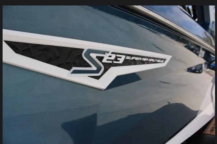 Slide: The Image of 2022 Nautique Super Air Nautique S23 logo on sleek blue boat exterior. - 17