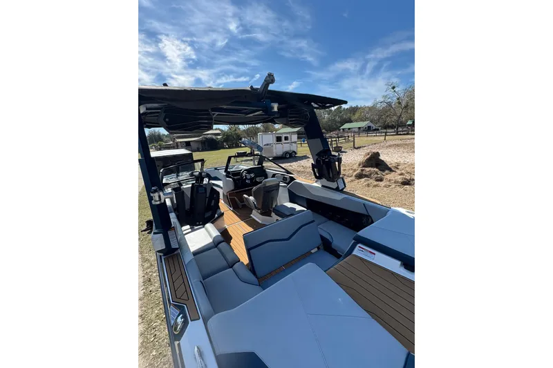 Slide: The Image of 2022 Nautique Super Air Nautique S23 boat interior with sleek seating and modern design. - 23