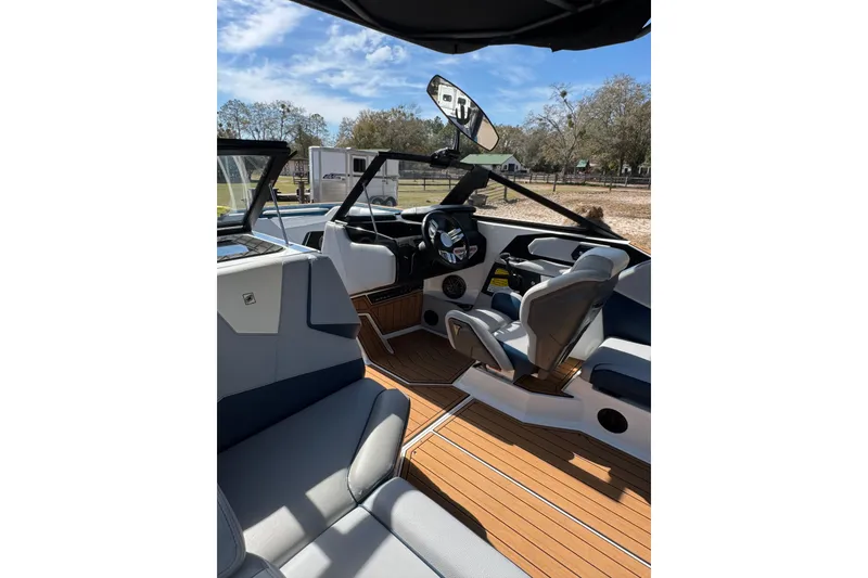 Slide: The Image of Interior of 2022 Nautique Super Air Nautique S23 boat with sleek seating and modern dashboard. - 26