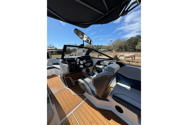 Slide: The Image of 2022 Nautique Super Air Nautique S23 interior with sleek design and wooden flooring. - 28