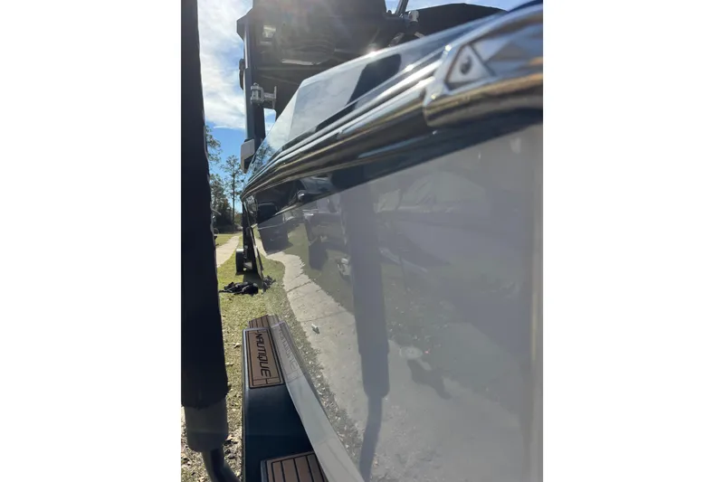 Slide: The Image of 2022 Nautique Super Air Nautique S23 boat side view in sunlight. - 29