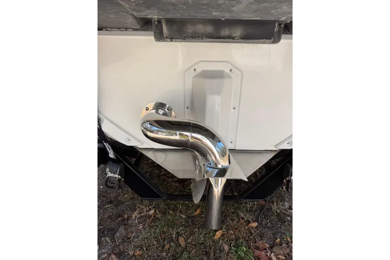 Slide: The Image of 2022 Nautique Super Air Nautique S23 exhaust pipe detail on grass. - 30