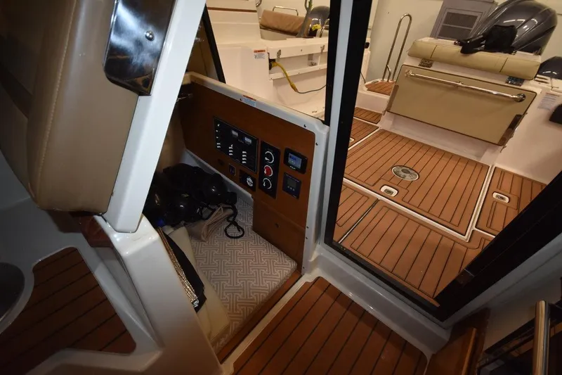 Slide: The Image of 2022 Ranger Tugs R-27 interior with control panel and teak flooring. - 10