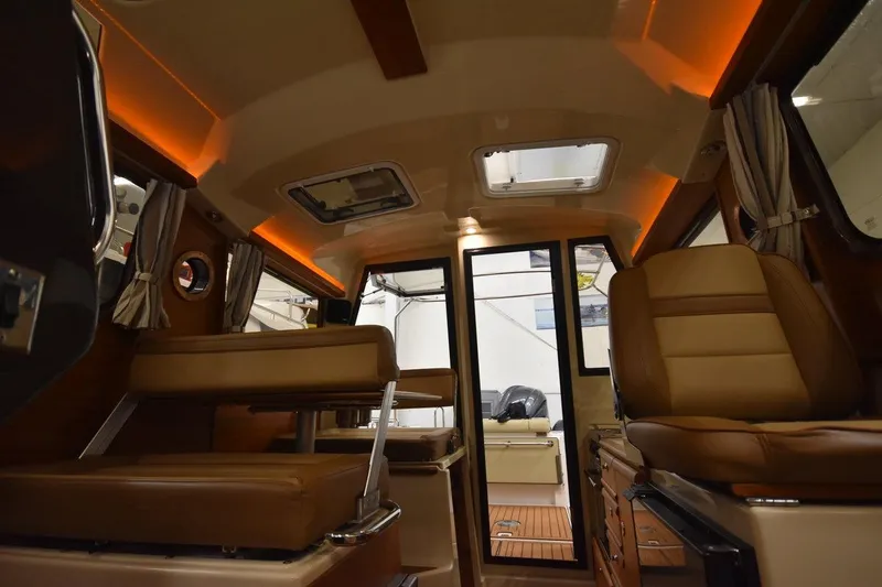 Slide: The Image of 2022 Ranger Tugs R-27 interior with leather seating and ambient lighting. - 20