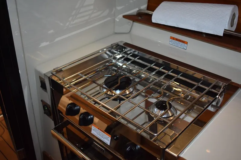 Slide: The Image of Stainless steel stove in 2022 Ranger Tugs R-27 boat kitchen area. - 21