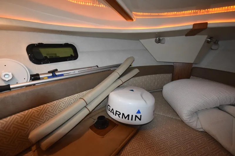 Slide: The Image of 2022 Ranger Tugs R-27 cabin interior with Garmin equipment and cozy bedding. - 25