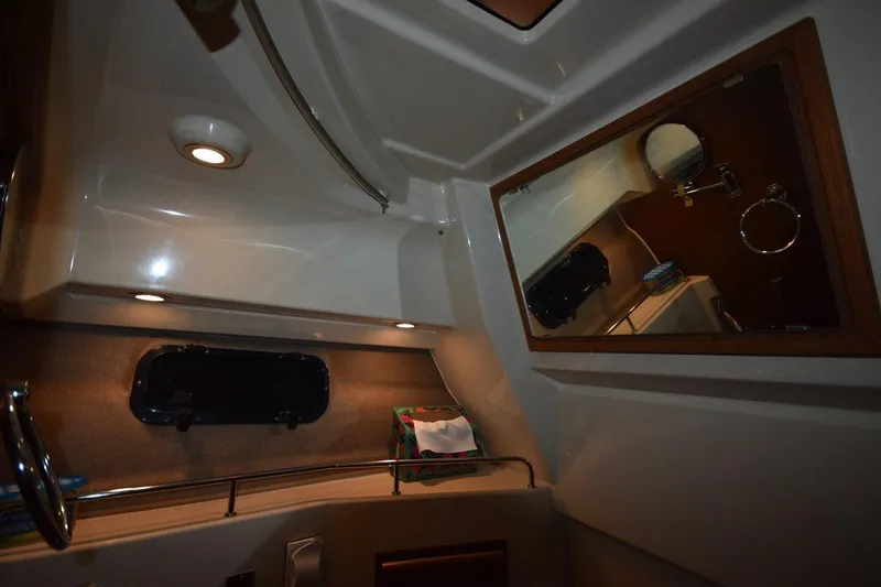 Slide: The Image of Interior of 2022 Ranger Tugs R-27 boat, featuring a mirror and ambient lighting. - 30