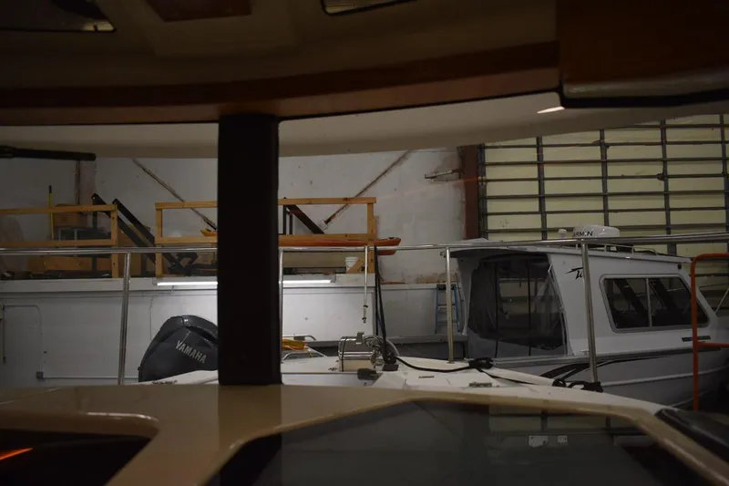 Slide: The Image of Indoor view of a 2022 Ranger Tugs R-27 boat in a storage facility. - 31