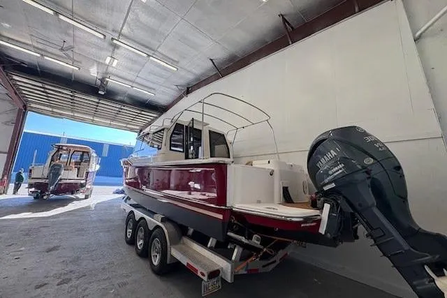 Slide: The Image of 2022 Ranger Tugs R-27 boat on trailer in warehouse with Yamaha outboard motor. - 5