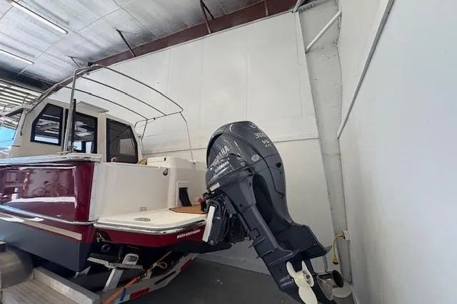 Slide: The Image of 2022 Ranger Tugs R-27 boat with Yamaha outboard motor in storage facility. - 7