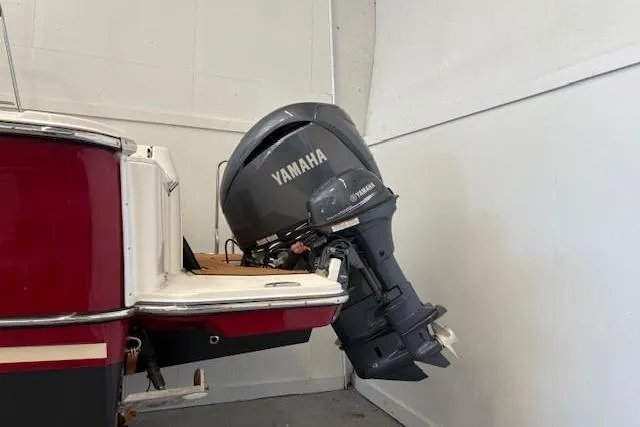 Slide: The Image of 2022 Ranger Tugs R-27 with Yamaha outboard motor in a garage setting. - 8