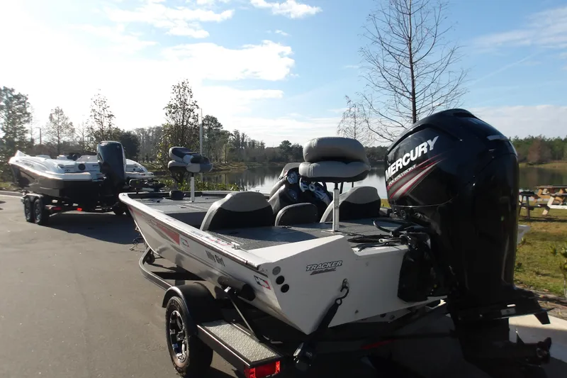 Slide: The Image of 2018 Tracker Pro Team 195 boat with Mercury engine by a lake. - 4