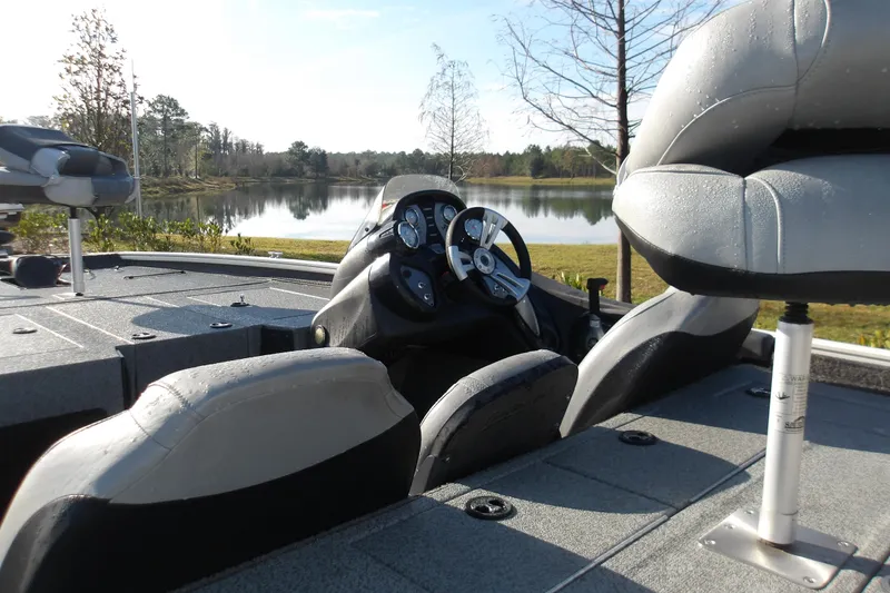 Slide: The Image of 2018 Tracker Pro Team 195 boat interior with steering wheel, seats, and lake view. - 7