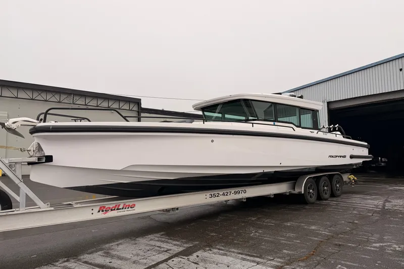 The Image of 2021 Axopar 37 XC Cross Cabin on trailer outside warehouse. - 0