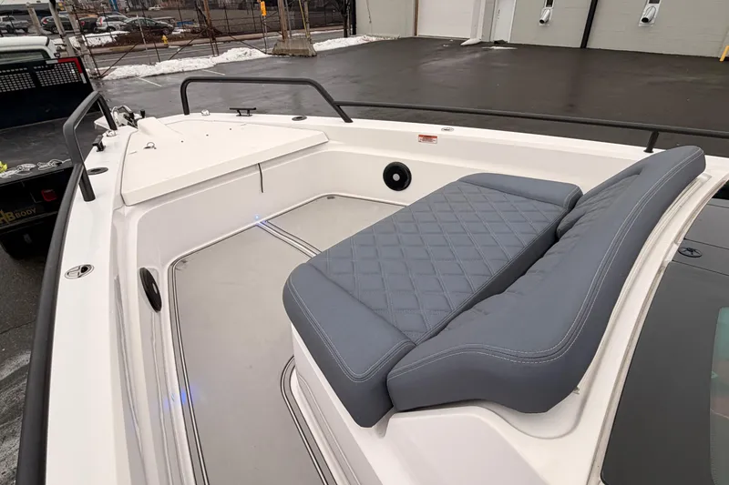 Slide: The Image of 2021 Axopar 37 XC Cross Cabin boat with gray cushioned seating on deck. - 10