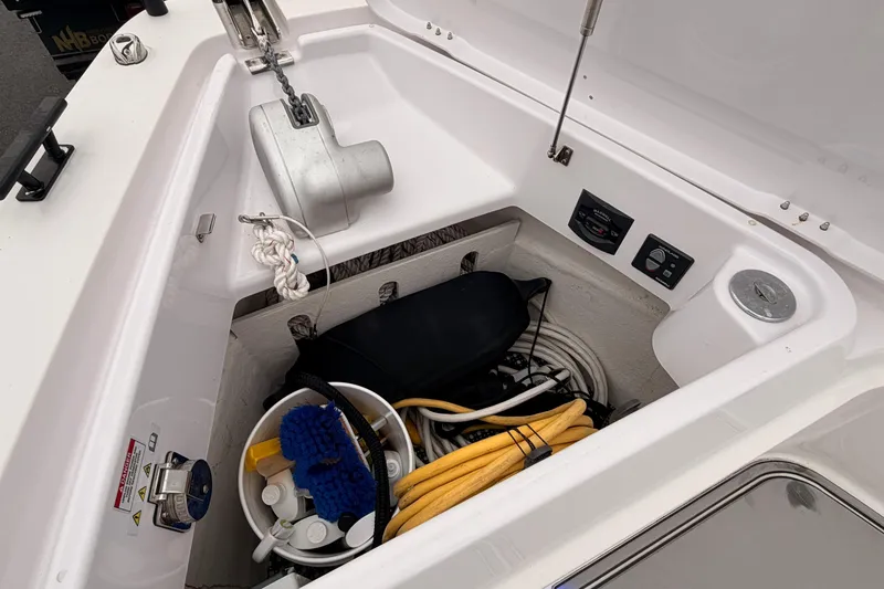 Slide: The Image of Storage compartment of 2021 Axopar 37 XC Cross Cabin with anchor and cleaning supplies. - 11