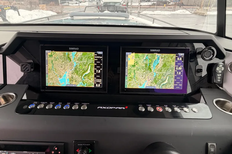 Slide: The Image of 2021 Axopar 37 XC Cross Cabin dashboard with dual Simrad navigation screens. - 15