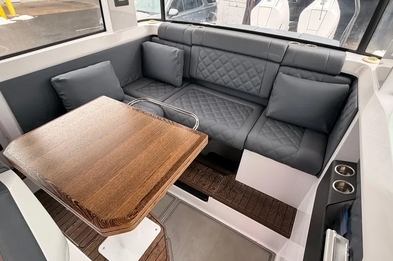 Slide: The Image of Luxurious interior of 2021 Axopar 37 XC Cross Cabin with plush seating and wooden table. - 20