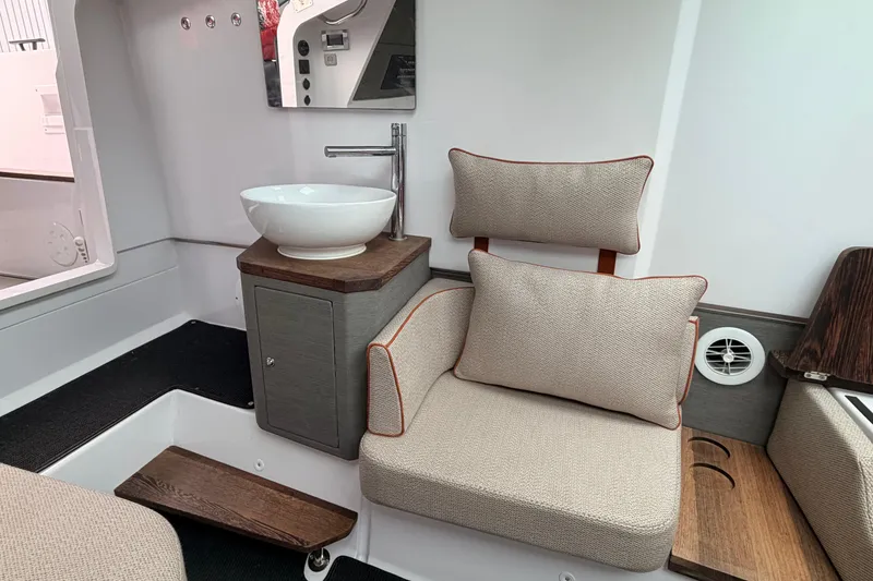 Slide: The Image of Interior of 2021 Axopar 37 XC Cross Cabin with modern sink and cushioned seating. - 25