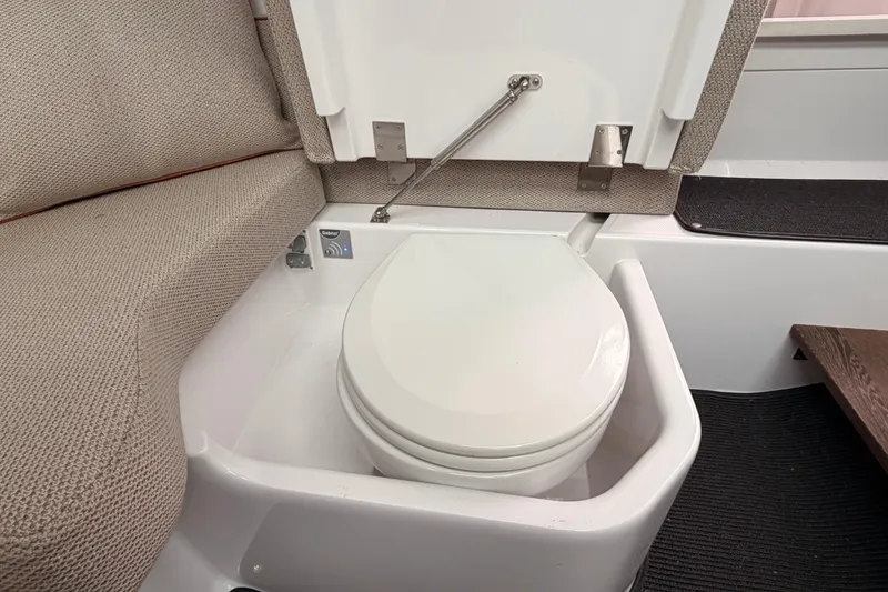 Slide: The Image of 2021 Axopar 37 XC Cross Cabin interior with compact marine toilet. - 26