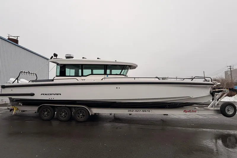 Slide: The Image of 2021 Axopar 37 XC Cross Cabin boat on trailer, side view. - 3