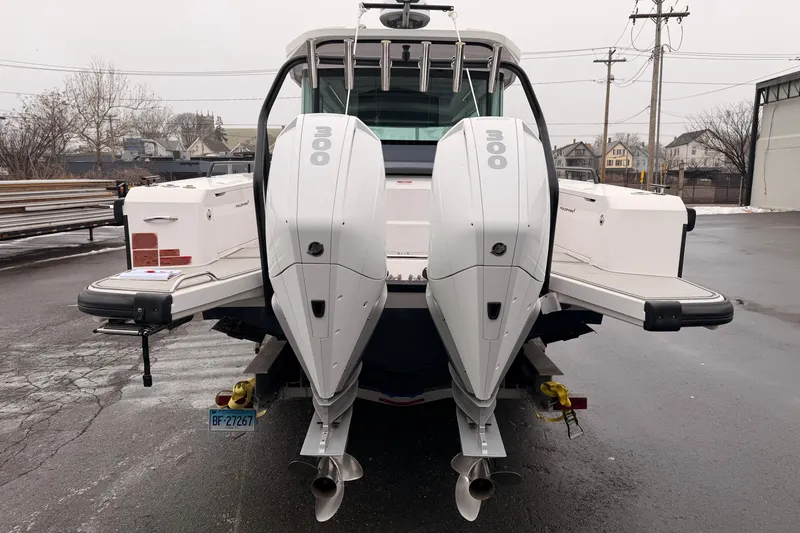 Slide: The Image of 2021 Axopar 37 XC Cross Cabin with dual 300 horsepower engines, rear view. - 4