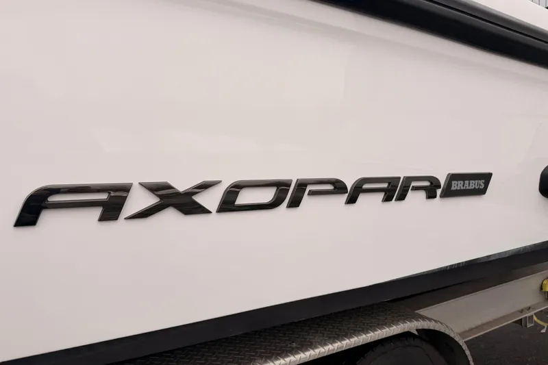 Slide: The Image of 2021 Axopar 37 XC Cross Cabin boat logo on white hull. - 6