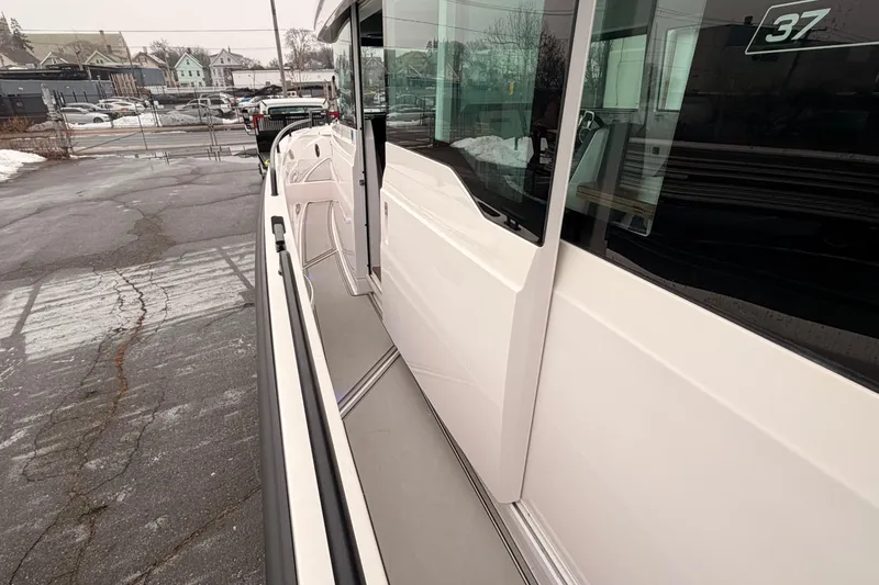 Slide: The Image of 2021 Axopar 37 XC Cross Cabin boat exterior view in a parking area. - 8