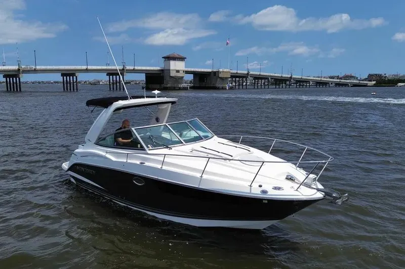 The Image of 2016 Monterey 295 Sport Yacht cruising near a bridge on a sunny day. - 0