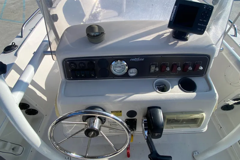 Slide: The Image of 1996 Pro-Line 170 Center Console boat dashboard with steering wheel and controls. - 10