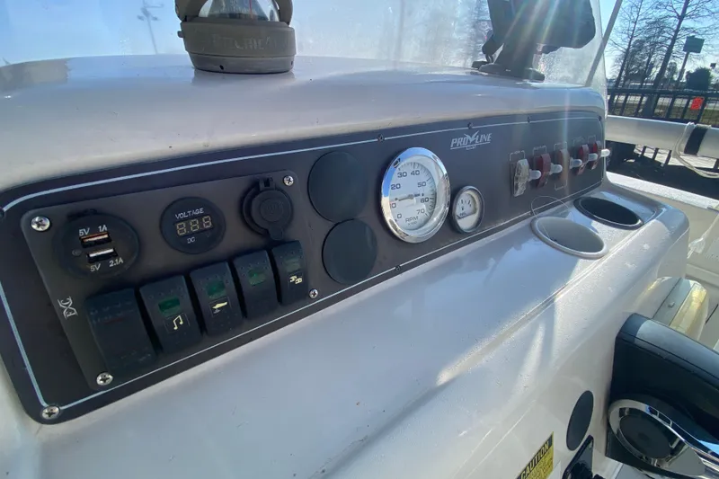 Slide: The Image of 1996 Pro-Line 170 Center Console dashboard with gauges, switches, and USB ports. - 11