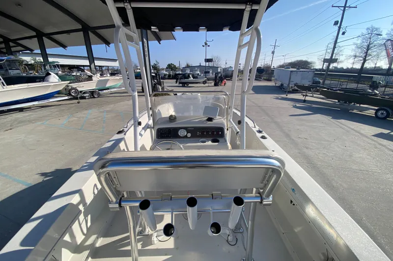 Slide: The Image of 1996 Pro-Line 170 Center Console boat in a marina, showcasing helm and seating area. - 14
