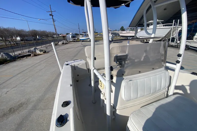 Slide: The Image of 1996 Pro-Line 170 Center Console boat with seating and console view, parked outdoors. - 17