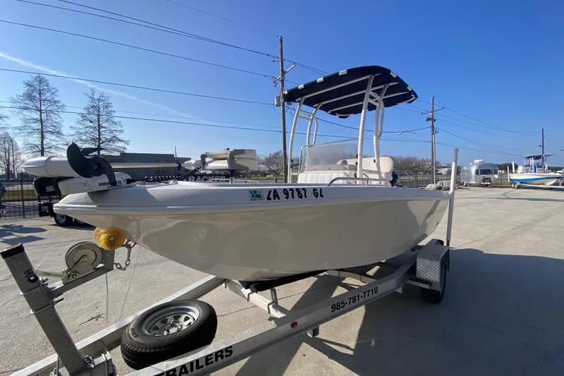 Slide: The Image of 1996 Pro-Line 170 Center Console boat on trailer under clear blue sky. - 8