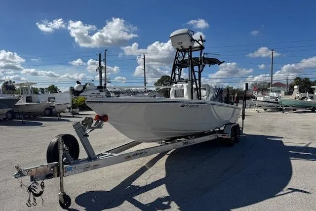 Slide: The Image of 2023 Pathfinder 2500 Hybrid boat on trailer under clear blue sky. - 3