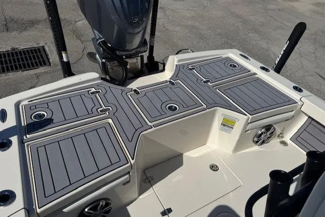 Slide: The Image of 2023 Pathfinder 2500 Hybrid boat deck with gray non-slip surface and storage compartments. - 4