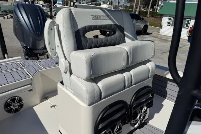 Slide: The Image of 2023 Pathfinder 2500 Hybrid boat seat with speakers, docked outdoors. - 7