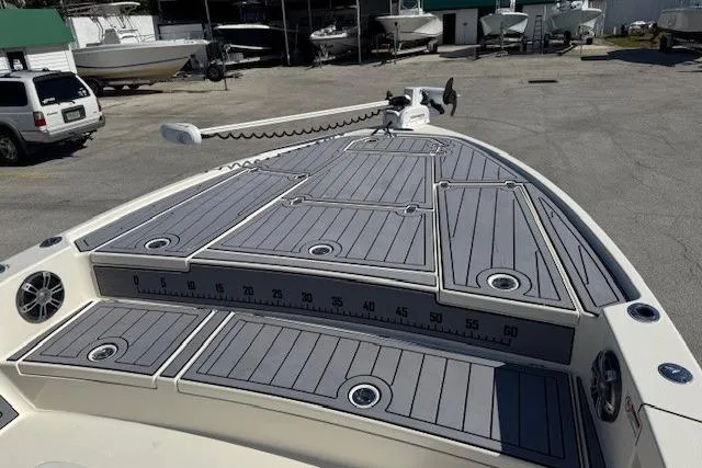 Slide: The Image of 2023 Pathfinder 2500 Hybrid boat deck with gray non-slip surface in a marina setting. - 8