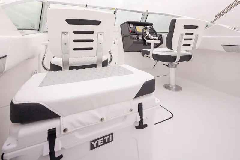 Slide: The Image of 2024 Blackfin 232DC boat interior with dual console seating and Yeti cooler. - 10