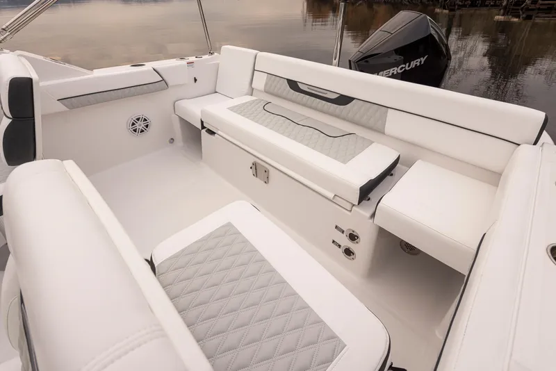 Slide: The Image of 2024 Blackfin 232DC Dual Console boat interior with white seating and Mercury engine. - 11