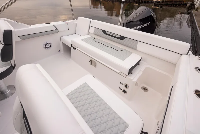 Slide: The Image of 2024 Blackfin 232DC Dual Console boat interior with cushioned seating and Mercury outboard motor. - 12