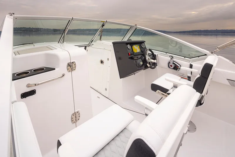 Slide: The Image of 2024 Blackfin 232DC Dual Console boat interior with modern dashboard and seating. - 13