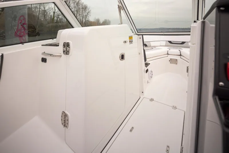 Slide: The Image of 2024 Blackfin 232DC Dual Console interior with sleek white design and spacious seating. - 17