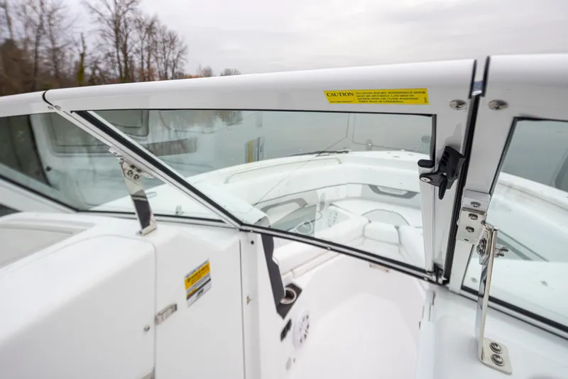 Slide: The Image of 2024 Blackfin 232DC Dual Console boat interior with sleek white design and glass windshield. - 20